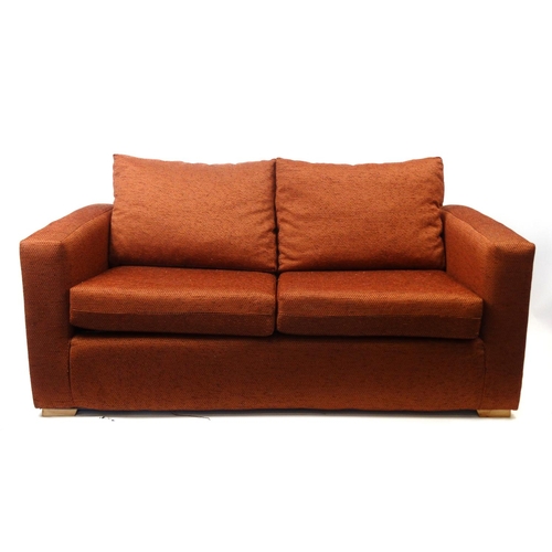 93 - Rust colour upholstered sofa bed, 165cm long, the bed 180cm x 112cm