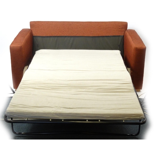 93 - Rust colour upholstered sofa bed, 165cm long, the bed 180cm x 112cm