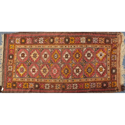 103 - Middle Eastern rug with geometric boarder onto a predominately brown ground, the central field decor... 