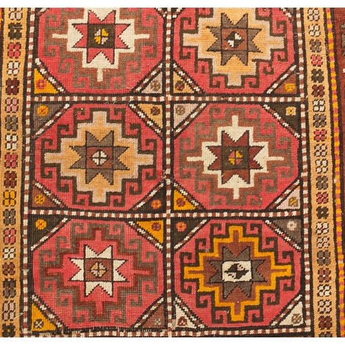 103 - Middle Eastern rug with geometric boarder onto a predominately brown ground, the central field decor... 