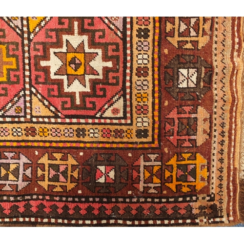 103 - Middle Eastern rug with geometric boarder onto a predominately brown ground, the central field decor... 