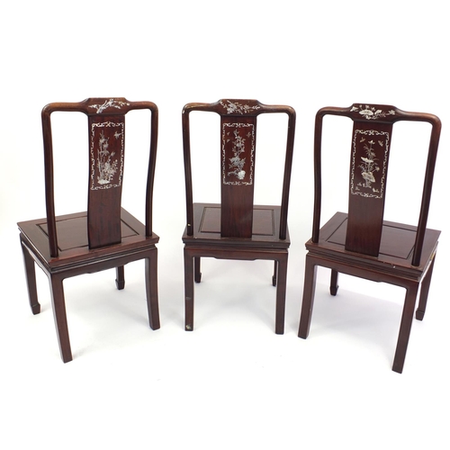 135 - Three oriental Chinese hardwood chairs all with mother of pearl inlay, each 98cm tall