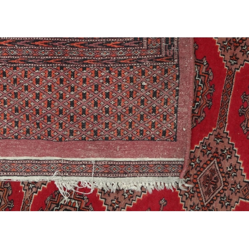 158 - Large rectangular Middle Eastern carpet with geometric border, the central field decorated with a co... 