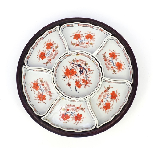 260 - Oriental ceramic sectional horderves dish set on swivel wooden and lidded base, 33cm diameter