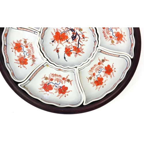 260 - Oriental ceramic sectional horderves dish set on swivel wooden and lidded base, 33cm diameter