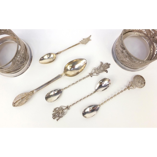 360 - Two silver filigree cup holders together with a group of silver filigree spoons