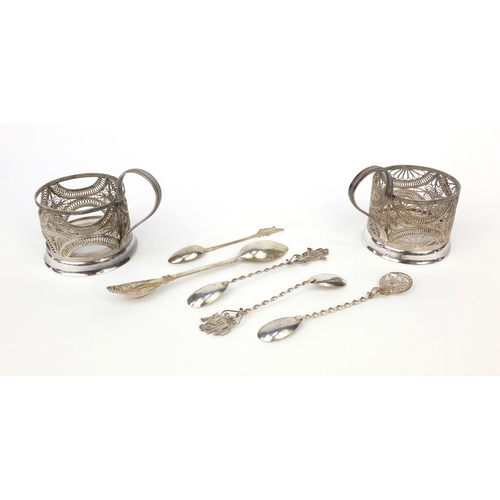 360 - Two silver filigree cup holders together with a group of silver filigree spoons