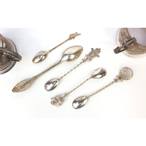 360 - Two silver filigree cup holders together with a group of silver filigree spoons