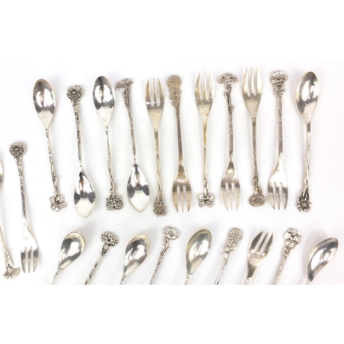 361 - Set of twelve unmarked silver spoons together with eleven silver coloured metal pickle forks, all wi... 