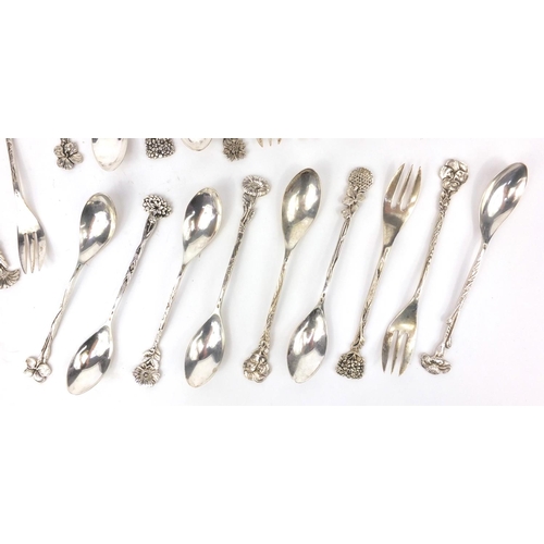 361 - Set of twelve unmarked silver spoons together with eleven silver coloured metal pickle forks, all wi... 