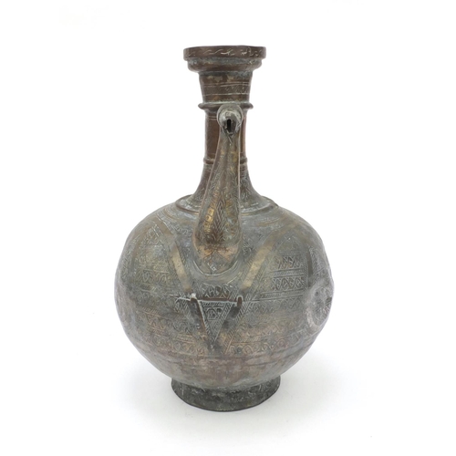 558 - Middle Eastern silvered metal brass water pot with chased abstract design, 36cm high