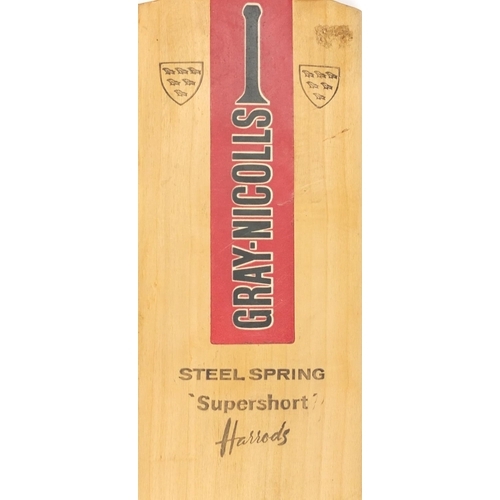 569 - Two cricket bats including a steel spring super short Harrods example and a Don Bradman Junior world... 