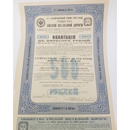 595 - Six Russian share certificates, some with attached bonds and stamps, the largest 41cm x 28cm