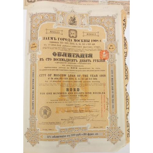 595 - Six Russian share certificates, some with attached bonds and stamps, the largest 41cm x 28cm