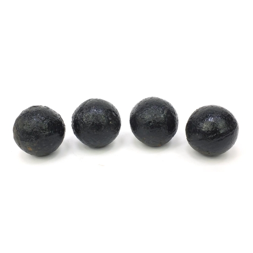 392 - Four antique cannon balls, each 7.5cm diameter