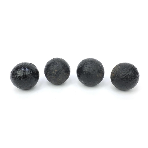 393 - Four antique cannon balls, each 7.5cm diameter