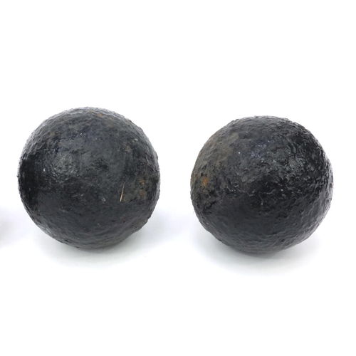 393 - Four antique cannon balls, each 7.5cm diameter