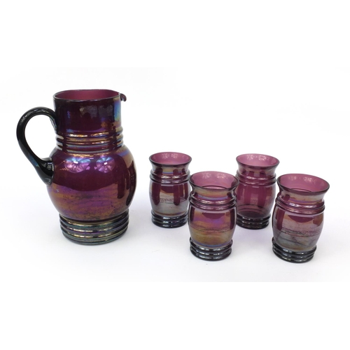 629 - Victorian purple iridescent glass jug together with four matching drinking glasses, the jug 23cm hig... 