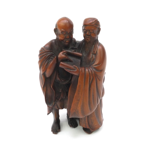 508 - Japanese finely carved hardwood Okimono of two elders looking at a scroll, signature to the base, 13... 