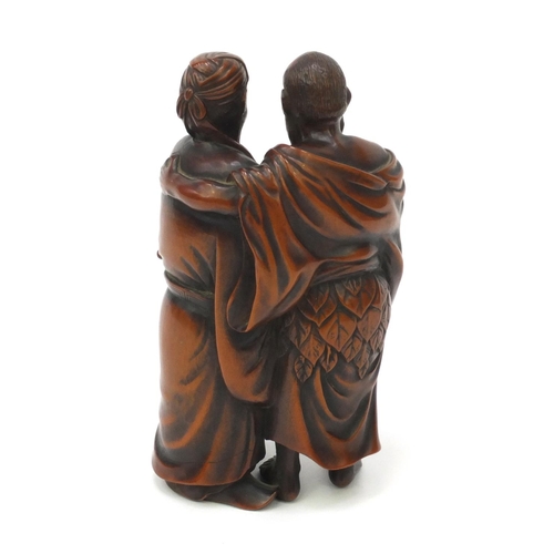 508 - Japanese finely carved hardwood Okimono of two elders looking at a scroll, signature to the base, 13... 