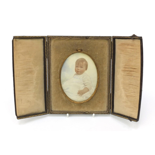 28 - Oval portrait miniature of a young child, housed in a gilt metal frame and a velvet lined leather ca... 