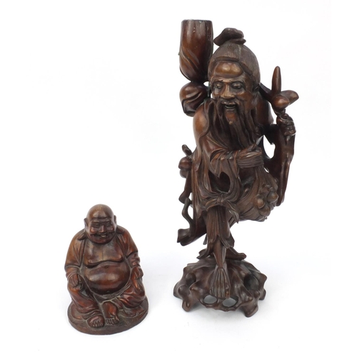 552 - Two Oriental hardwood carvings, one of a lamp base modelled as an elder and one of a seated Buddha, ... 