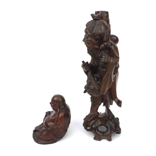 552 - Two Oriental hardwood carvings, one of a lamp base modelled as an elder and one of a seated Buddha, ... 