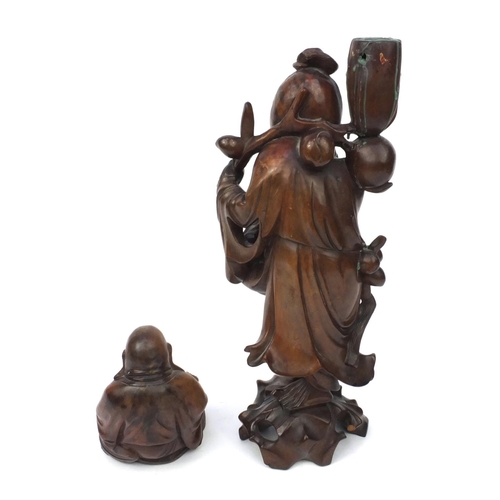 552 - Two Oriental hardwood carvings, one of a lamp base modelled as an elder and one of a seated Buddha, ... 