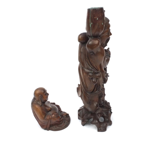 552 - Two Oriental hardwood carvings, one of a lamp base modelled as an elder and one of a seated Buddha, ... 