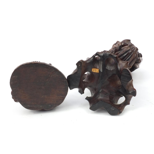 552 - Two Oriental hardwood carvings, one of a lamp base modelled as an elder and one of a seated Buddha, ... 