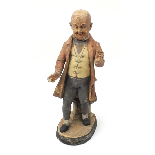 617 - Large terracotta figure of Mr Pickwick leaning against a font, 46cm high