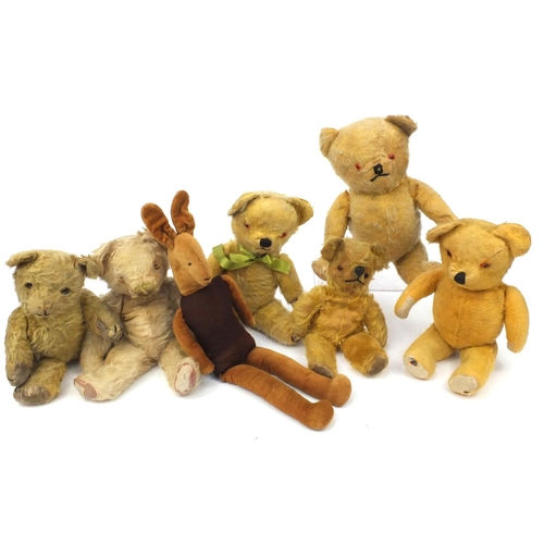 444 - Group of seven mostly golden teddy bears including some straw filled with jointed limbs, the tallest... 