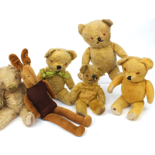 444 - Group of seven mostly golden teddy bears including some straw filled with jointed limbs, the tallest... 