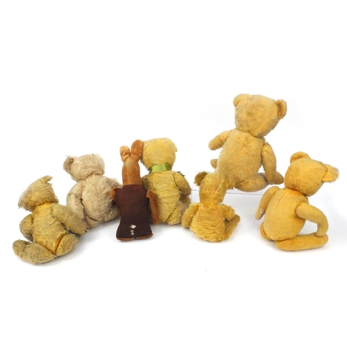 444 - Group of seven mostly golden teddy bears including some straw filled with jointed limbs, the tallest... 