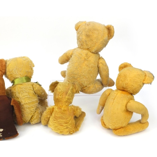 444 - Group of seven mostly golden teddy bears including some straw filled with jointed limbs, the tallest... 