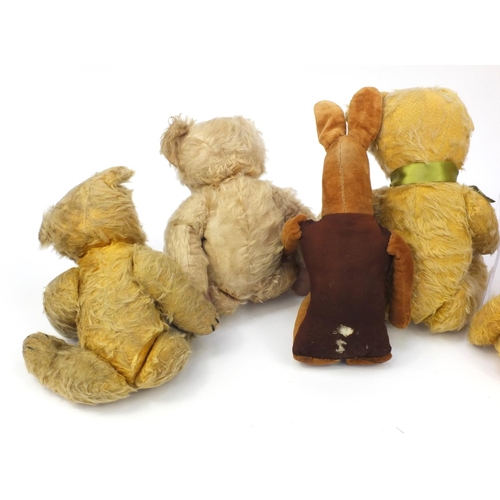 444 - Group of seven mostly golden teddy bears including some straw filled with jointed limbs, the tallest... 