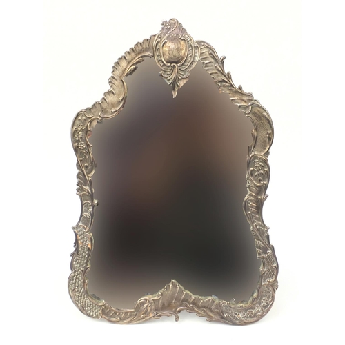 740 - Large unmarked silver Rococo style bevelled edge easel mirror, with C scroll decoration, the brass e... 