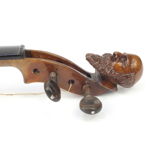 349 - Two old wooden violins, one with figural scroll and Gaspard duiffo Praggard label, the other with an... 