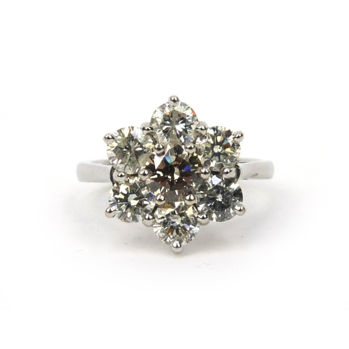 840 - 18ct white gold brilliant cut diamond flower head ring, size N, approximate weight 5.2g