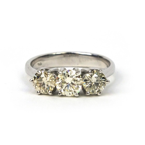 820 - 18ct gold three stone brilliant cut diamond ring, size L, approximate weight 4.0g