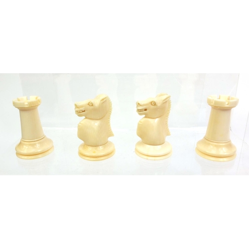 409 - Cantonese turned ivory half stained chess set, the tallest piece, 9cm high