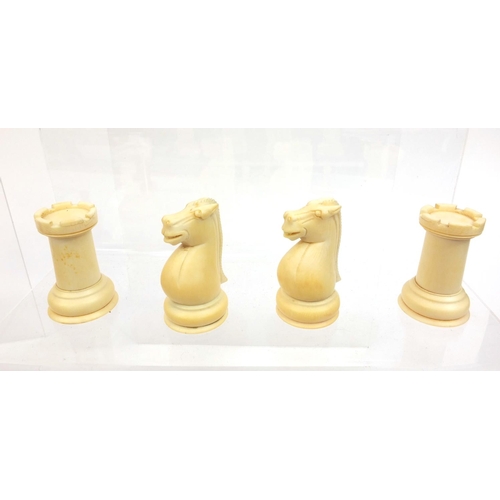 410 - Cantonese turned ivory half stained chess set, the tallest piece 10cm high
