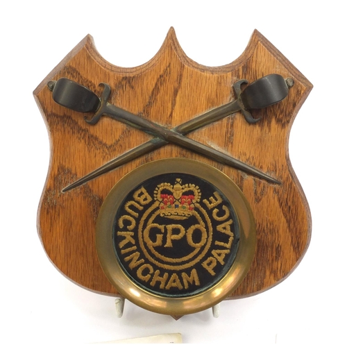 260 - Buckingham Palace GPO cloth patch mounted on an oak shield, together with a Christmas card from the ... 