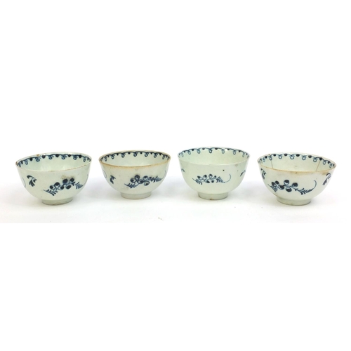 624 - Four 19th Century pottery tea bowls sparsely hand painted with a floral decoration, each 5cm high