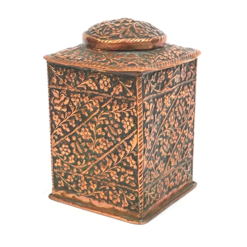 329 - Middle Eastern copper square tea caddy profusely embossed with flowers and foliage, 17cm high