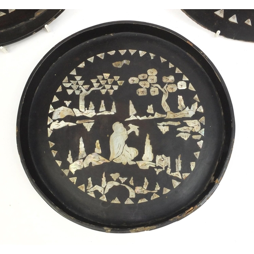 558 - Two Chinese black lacquered trays together with one other, each inlaid with Mother of Pearl and deco... 