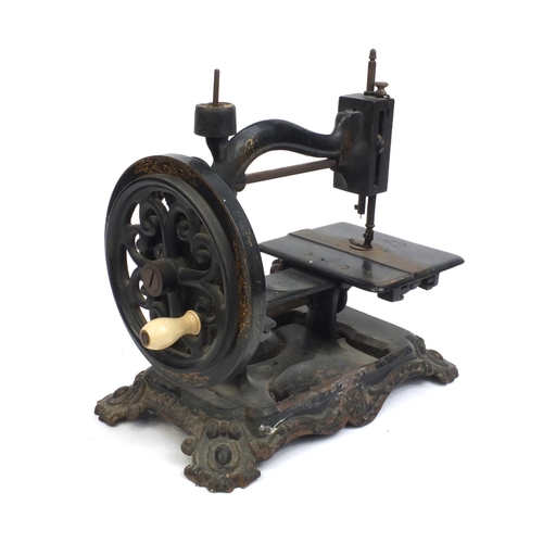 57 - Victorian cast iron sewing machine with gilt decoration, 31cm high