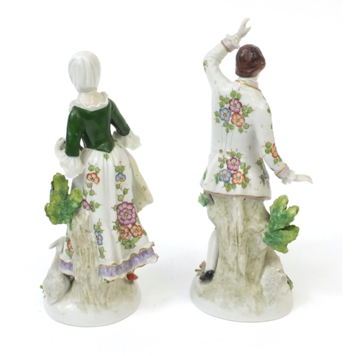595 - Pair of continental hand painted porcelain figures, one of a dancing boy and one of a female, both s... 