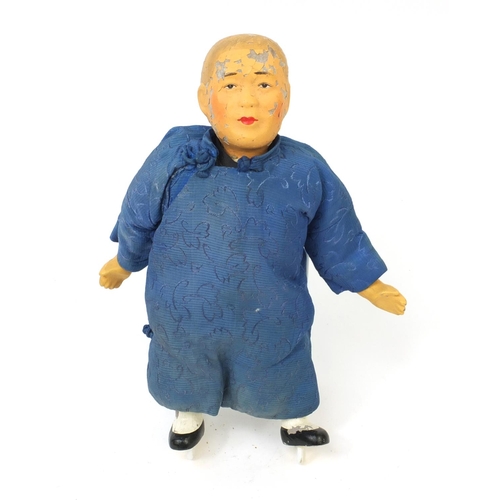 561 - Oriental doll of a man with composite head and limbs , with straw filled body, 28cm high