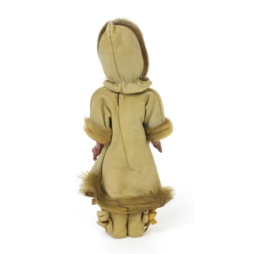 442 - Inuit doll wearing a leather and fur hooded jacket with open close eyes, 20cm high